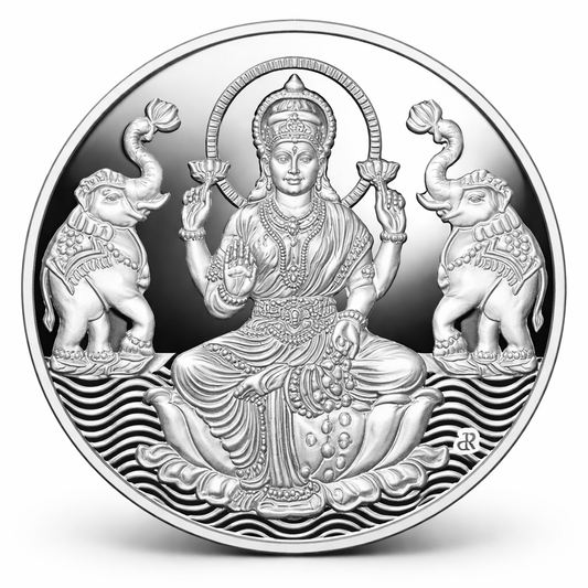 Silver coin with laxmi deity and elephants design on a white background