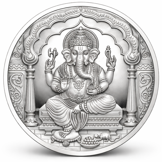 Circular silver coin with an intricate design of a seated ganesha figure on a white background
