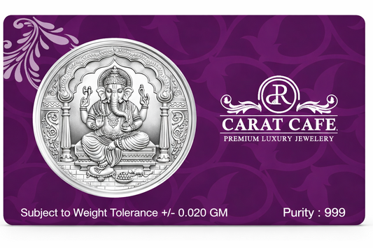 Silver coin on a purple card with Carat Cafe branding
