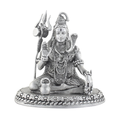Silver statue of a seated deity shiva with a shankha and mace on a white background
