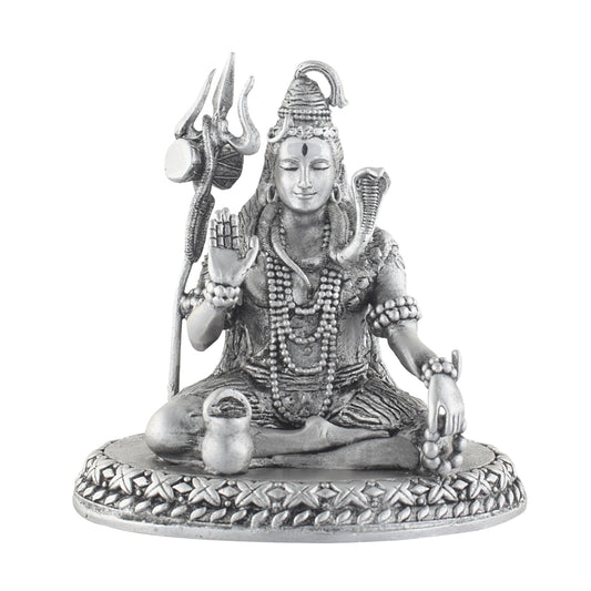 Silver statue of a seated deity shiva with a shankha and mace on a white background