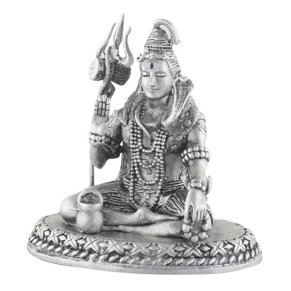 Statue of a seated shiva with a trident on a white background