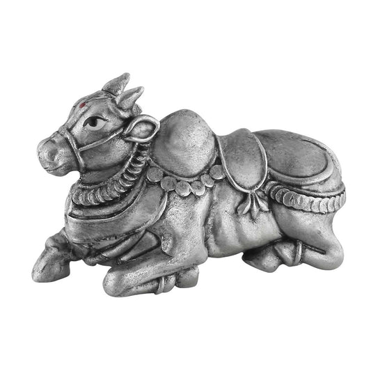 Silver bull figurine with decorative elements on a white background