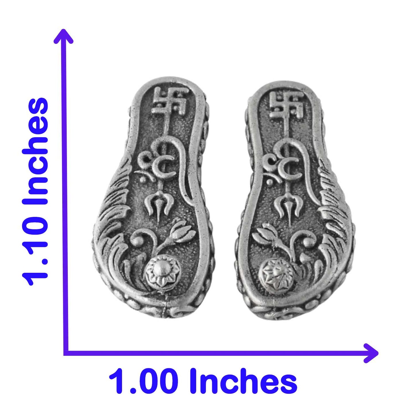 Pair of silver laxmi paduka with intricate designs and measurements on a white background