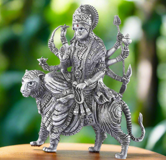 silver_durga_idol_on_table