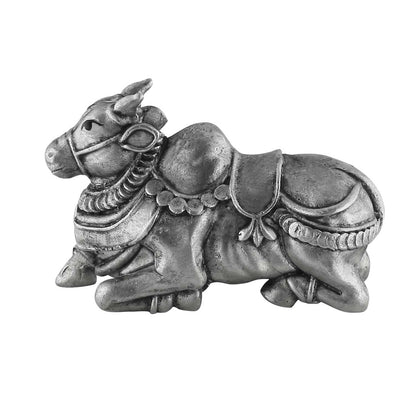 Decorative metal bull figurine with intricate details on a white background
