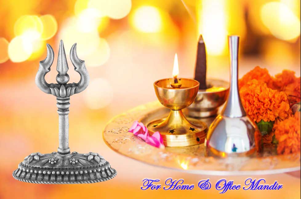 Decorative items including a trident, lit candle, and flowers on a blurred background