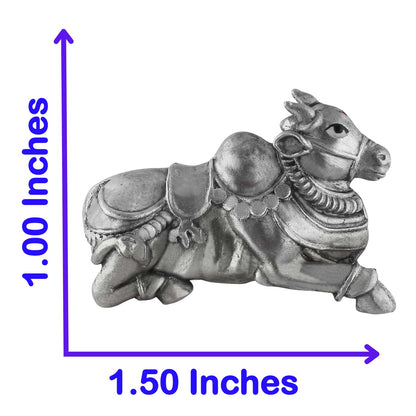 Silver bull figurine with measurements on a white background